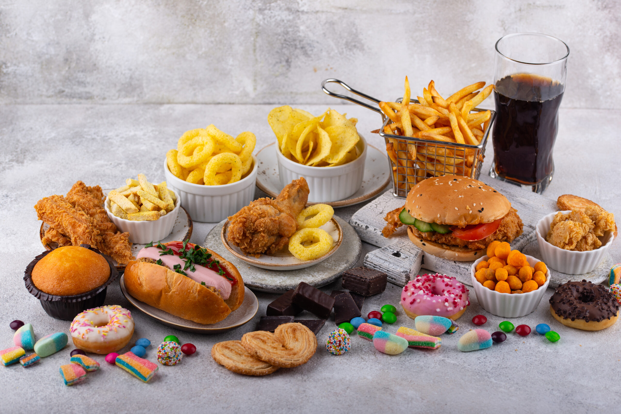 Assortment of unhealthy junk food. Burger, french fries, hot dog, snack and sweets