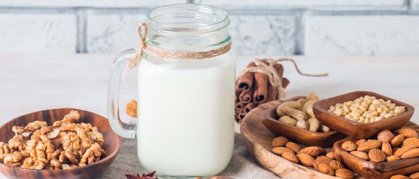 collection of plant-based milk on table such as cashew milk, pistachio milk etc