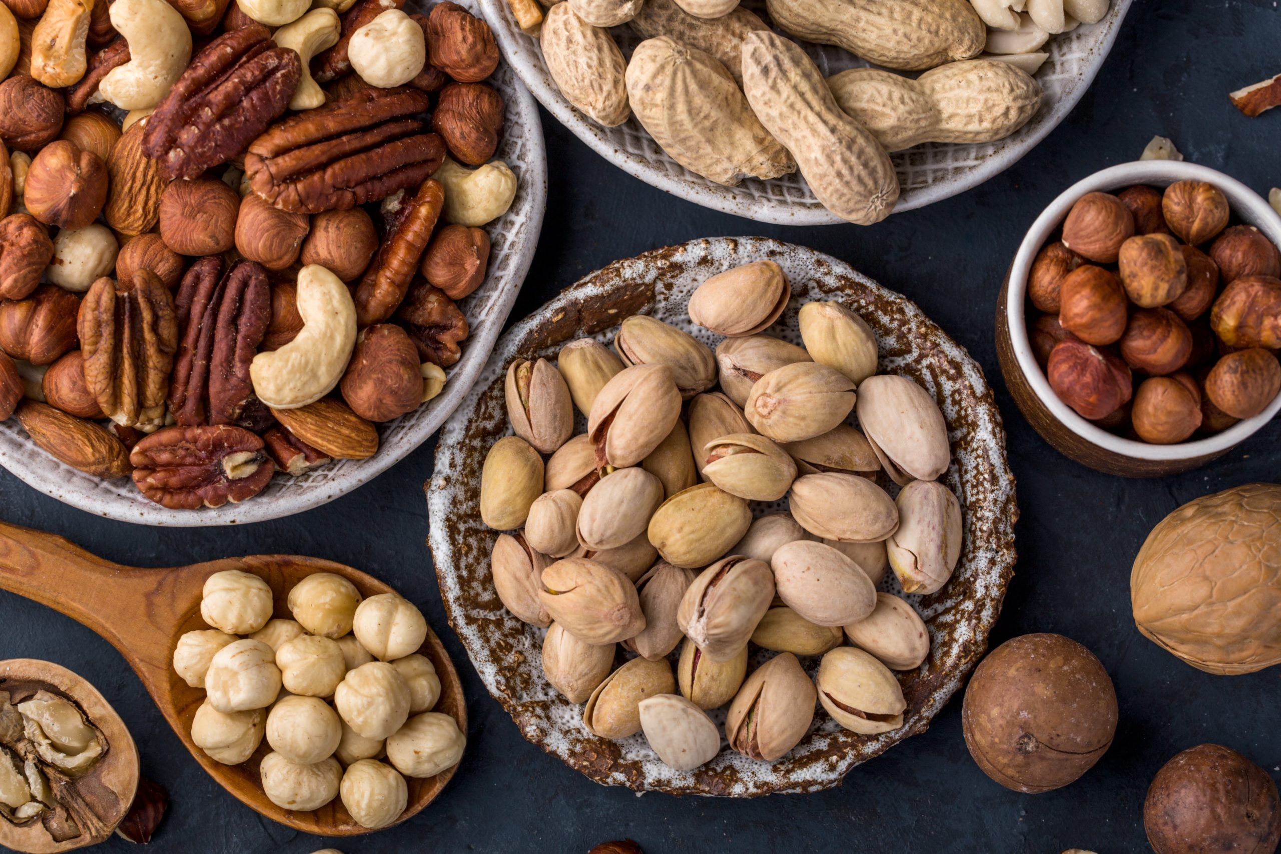 variety of nuts in plates healthy snack